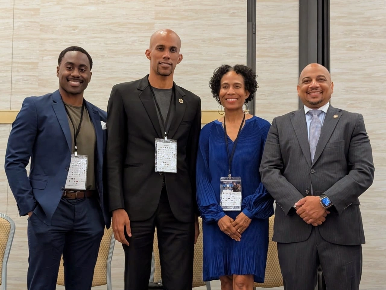 Four attendees gather for a group photo at the 126th National Business League Conference in Atlanta.